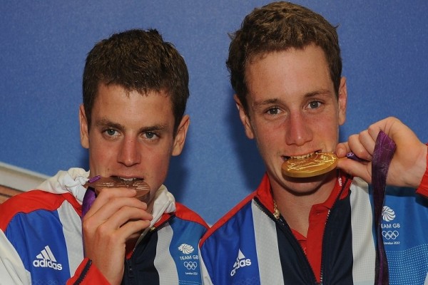 Alistair and Jonathan Brownlee test their medals